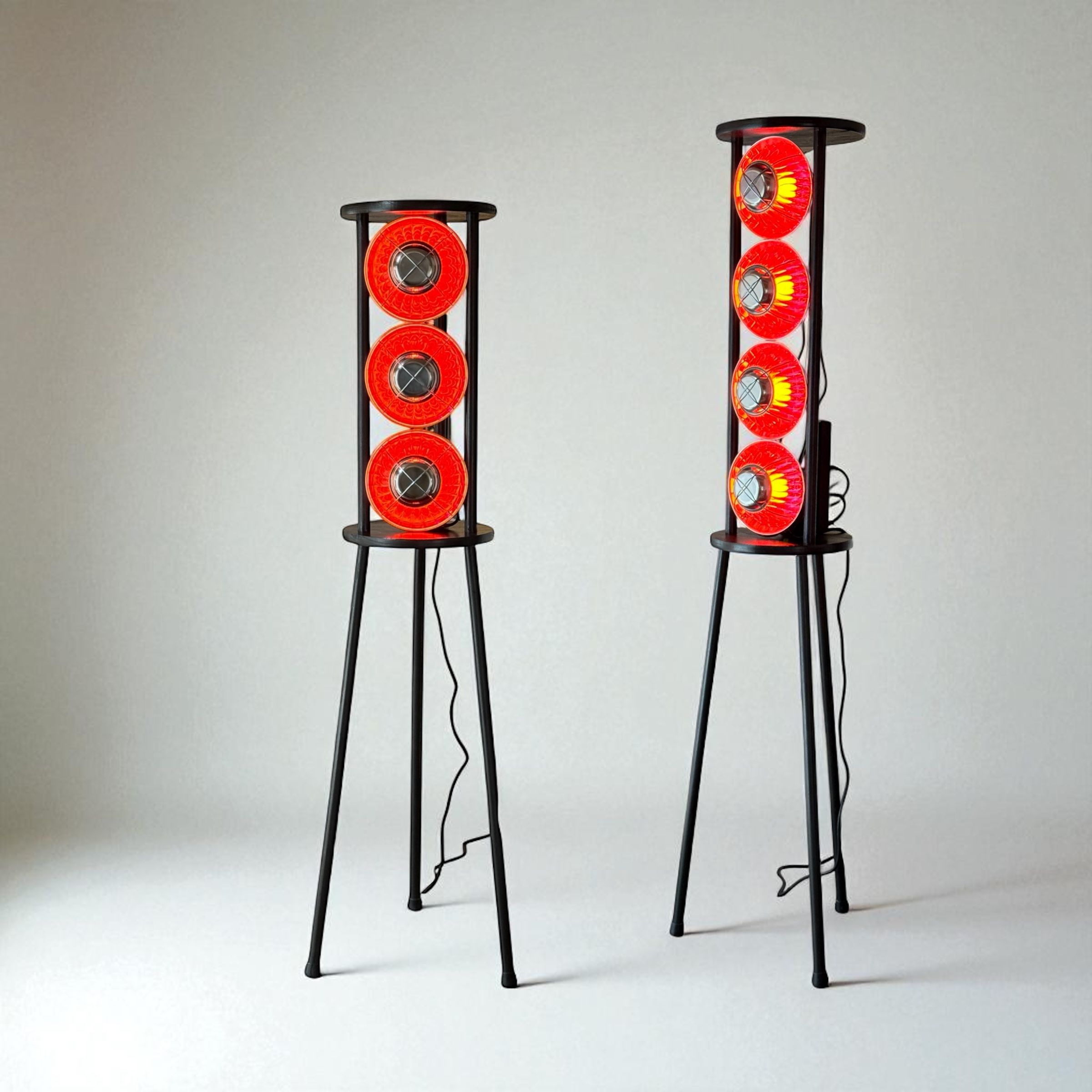 Two tall lighting objects containing vertically arranged glowing red elements.