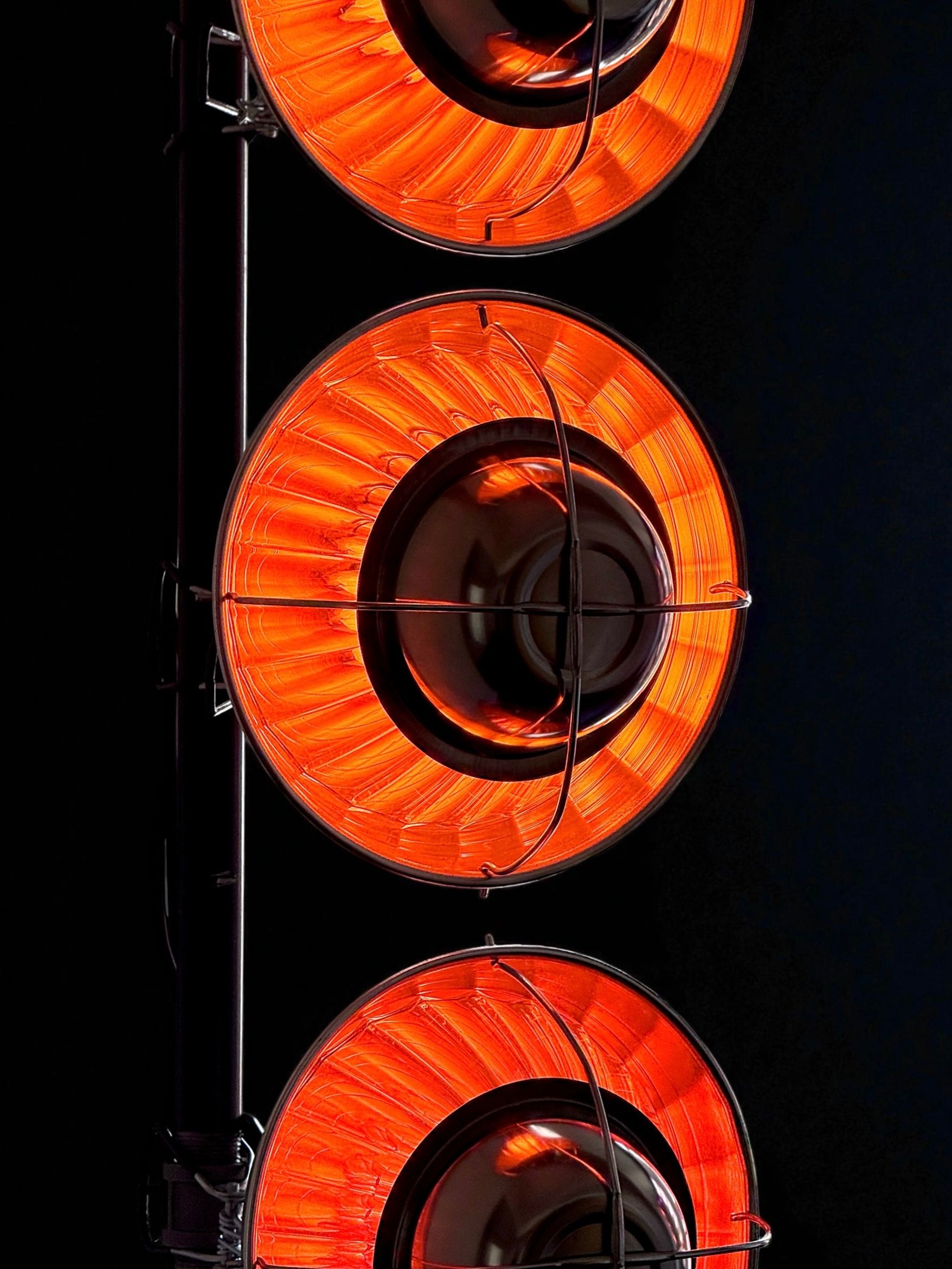 Close-up of glowing circular red heating and light elements.